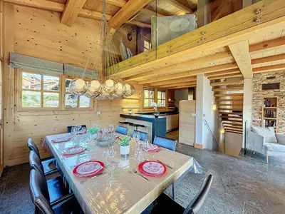 a dining room with a long table with red plates at Superbe chalet au calme avec jardin, garage et Wifi - FR-1-560-130 in Combloux