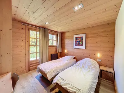 a bedroom with two beds in a log cabin at Superbe chalet au calme avec jardin, garage et Wifi - FR-1-560-130 in Combloux