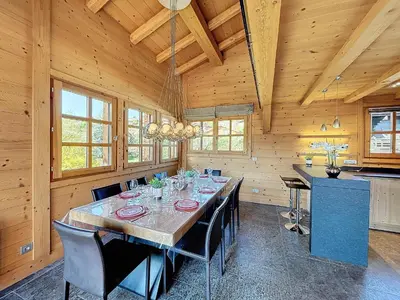 a dining room with a long table and chairs at Superbe chalet au calme avec jardin, garage et Wifi - FR-1-560-130 in Combloux