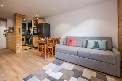 a living room with a couch and a table at Appartement 