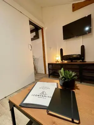 a book sitting on a table in a living room at Al_titude1138 in Les Contamines-Montjoie
