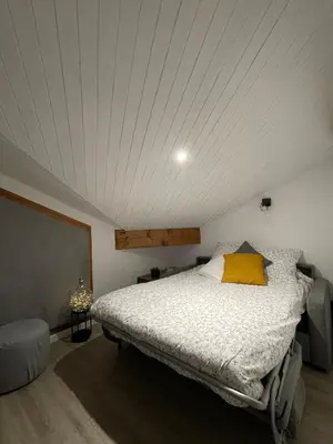 a bedroom with a large bed in a attic at Al_titude1138 in Les Contamines-Montjoie