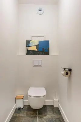a bathroom with a toilet and a picture on the wall at White Pearl A03 - Alpes Travel - Central Chamonix - Sleeps 2-4 in Chamonix-Mont-Blanc