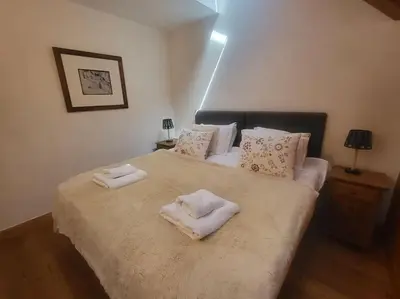 a bedroom with a large bed with towels on it at C11, 72m2, 3 bedrooms, next to the ski lift in Samoëns