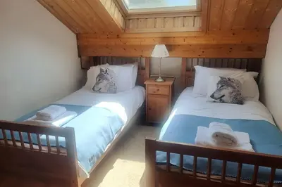 two beds in a room with a attic at C11, 72m2, 3 bedrooms, next to the ski lift in Samoëns