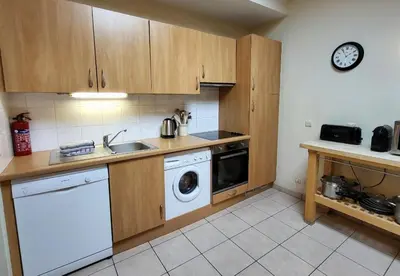 a kitchen with a sink and a washing machine at C11, 72m2, 3 bedrooms, next to the ski lift in Samoëns