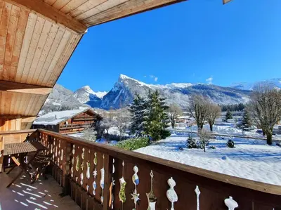 a balcony with a view of a snow covered mountain at C11, 72m2, 3 bedrooms, next to the ski lift in Samoëns