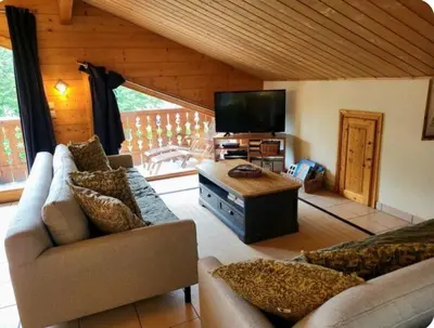 a living room with a couch and a tv at C11, 72m2, 3 bedrooms, next to the ski lift in Samoëns