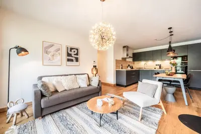 a living room with a couch and a table at Apartment Opale Megève - by EMERALD STAY in Megève