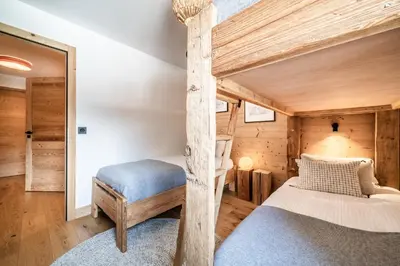a bedroom in a log cabin with a bunk bed at Apartment Opale Megève - by EMERALD STAY in Megève