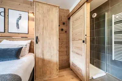 a bedroom with a shower and a bed in a room at Apartment Opale Megève - by EMERALD STAY in Megève