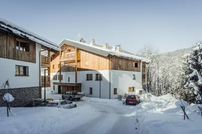 a house in the snow with cars parked at Apartment Opale Megève - by EMERALD STAY in Megève