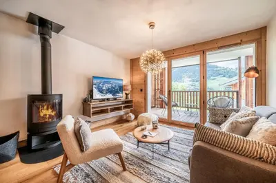 a living room with a couch and a fireplace at Apartment Opale Megève - by EMERALD STAY in Megève