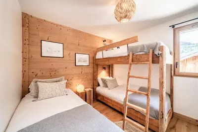 a bedroom with two bunk beds and a ladder at Apartment Opale Megève - by EMERALD STAY in Megève