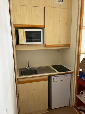 a small kitchen with a sink and a microwave at Aiguille du midi in Chamonix-Mont-Blanc