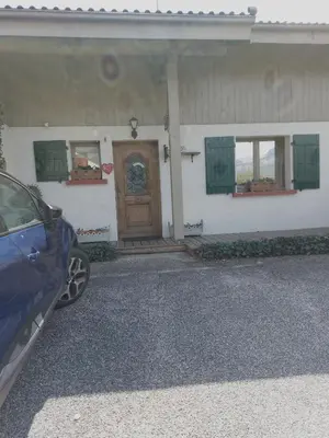 a car parked in front of a house with a door at Chambre privee in Sallanches
