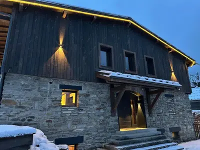 a house with snow on the roof and windows at Chalet 8 Etoiles in Chamonix-Mont-Blanc
