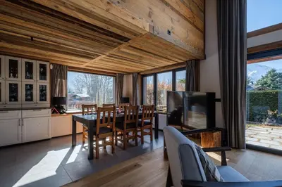 a kitchen and dining room with a table and chairs at Chalet 8 Etoiles in Chamonix-Mont-Blanc