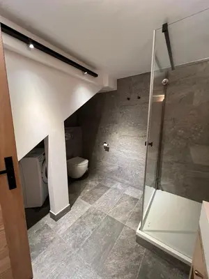 a bathroom with a toilet and a walk in shower at Chalet 8 Etoiles in Chamonix-Mont-Blanc