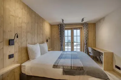 a bedroom with a large bed and a window at Chalet familial vue MontBlanc in Saint-Gervais-les-Bains