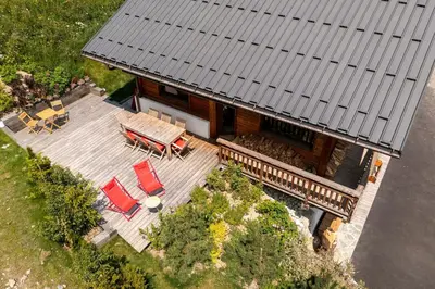 an overhead view of a house with a deck and chairs at Chalet familial vue MontBlanc in Saint-Gervais-les-Bains