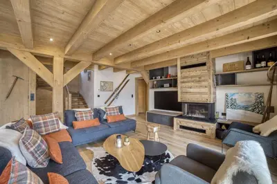 a living room with blue couches and a wooden ceiling at Chalet familial vue MontBlanc in Saint-Gervais-les-Bains