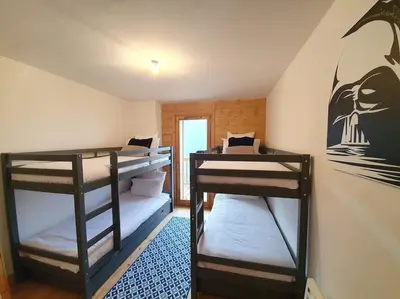 a room with two bunk beds in a room at Saskya 5 65m2, 2 bedrooms, next to the ski lift in Samoëns