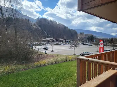 a view of a parking lot from the porch of a house at Saskya 5 65m2, 2 bedrooms, next to the ski lift in Samoëns