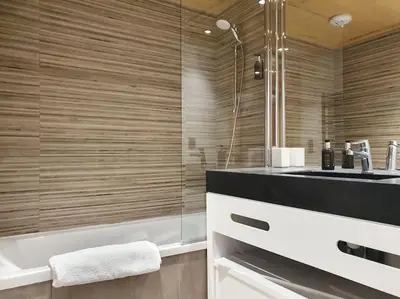 a bathroom with a shower and a sink and a tub at Saskya 5 65m2, 2 bedrooms, next to the ski lift in Samoëns