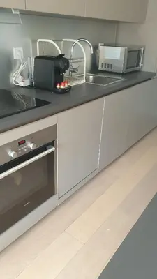 a kitchen with a sink and a counter top at Duplex les Myrtilles LES CARROZ centre station in Les Carroz d'Araches