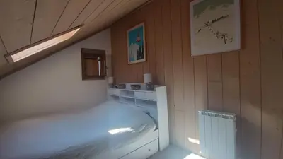 a small bedroom with a bed and a sink at Duplex les Myrtilles LES CARROZ centre station in Les Carroz d'Araches
