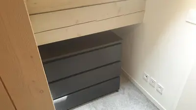 a drawer in a closet with a wooden cabinet at Duplex les Myrtilles LES CARROZ centre station in Les Carroz d'Araches