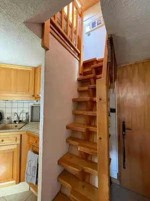 a staircase in a tiny house with a kitchen at L'Appartement des Pistes in Saint-Gervais-les-Bains