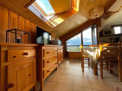 a kitchen with wooden cabinets and a skylight at L'Appartement des Pistes in Saint-Gervais-les-Bains