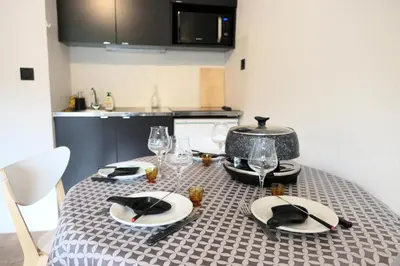a table with plates and wine glasses on it at Résidence Amethyste - Améthyste 1219 MAE-1641 in Mémontel
