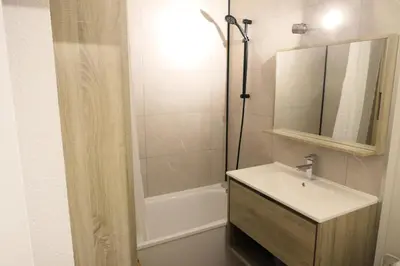 a bathroom with a sink and a shower with a mirror at Résidence Amethyste - Améthyste 1219 MAE-1641 in Mémontel