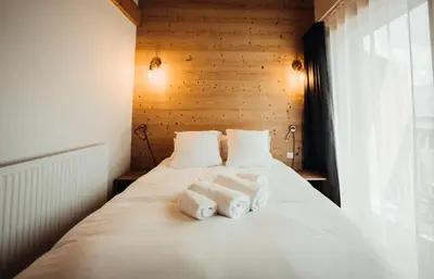 a bedroom with a bed with towels on it at Chalet familial de 6 chambres dominant Saint-Gervais classé 4 étoiles in Saint-Gervais-les-Bains