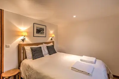 a bedroom with a bed with white sheets and pillows at La Tramousse - - Alpes Travel - Chamonix Centre - Sleeps 6 in Chamonix-Mont-Blanc