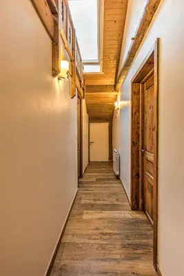 a hallway with wood floors and a skylight at La Tramousse - - Alpes Travel - Chamonix Centre - Sleeps 6 in Chamonix-Mont-Blanc