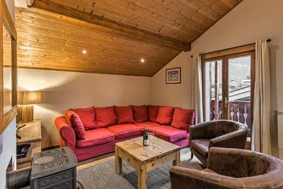 a living room with a red couch and chairs at La Tramousse - - Alpes Travel - Chamonix Centre - Sleeps 6 in Chamonix-Mont-Blanc