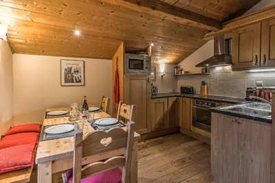 a kitchen with a table and chairs in a room at La Tramousse - - Alpes Travel - Chamonix Centre - Sleeps 6 in Chamonix-Mont-Blanc