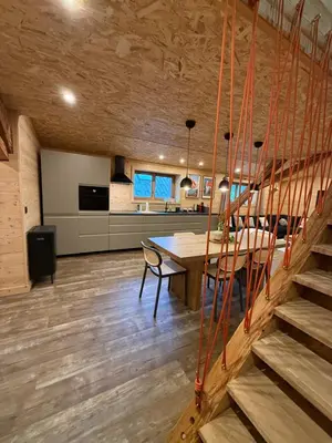 a kitchen and dining room with a table and stairs at Chalet Atmosphere Chamonix City Center Large T3 in Chamonix-Mont-Blanc