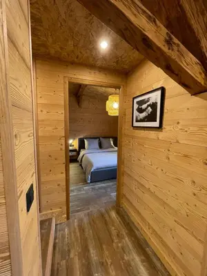 a bedroom with a bed in a wooden cabin at Chalet Atmosphere Chamonix City Center Large T3 in Chamonix-Mont-Blanc