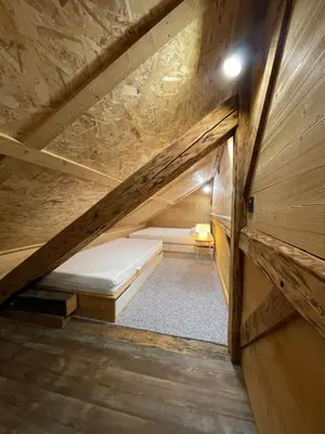 a small attic room with a bed in the attic at Chalet Atmosphere Chamonix City Center Large T3 in Chamonix-Mont-Blanc