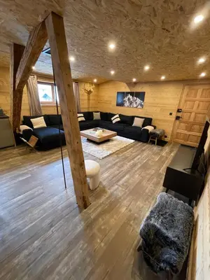 a living room with a couch and a table at Chalet Atmosphere Chamonix City Center Large T3 in Chamonix-Mont-Blanc