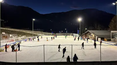 a group of people skating on an ice rink at night at Superbe chalet 10 personnes 5 chambres Les Houches in Les Houches