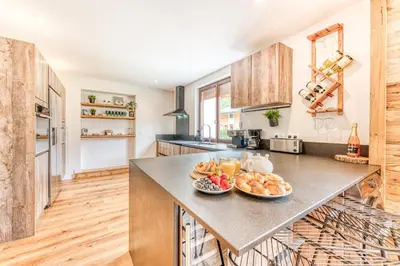 a kitchen with a counter with a bowl of fruit on it at Sauna Bain Nordique Cinéma Vue Montange in Chamonix-Mont-Blanc