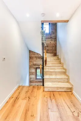 a staircase in a house with wooden floors at Sauna Bain Nordique Cinéma Vue Montange in Chamonix-Mont-Blanc