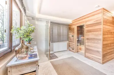 a bathroom with a shower and a vase of flowers on a table at Sauna Bain Nordique Cinéma Vue Montange in Chamonix-Mont-Blanc