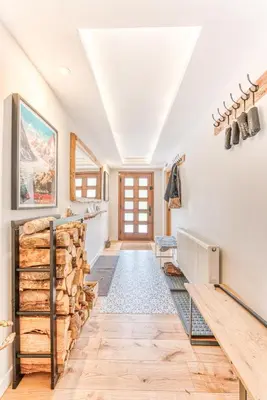 a hallway with a stack of logs in a house at Sauna Bain Nordique Cinéma Vue Montange in Chamonix-Mont-Blanc